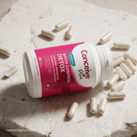 Conceive Plus birth control detox supplement bottle with capsules on a marble surface