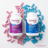 Two Conceive Plus fertility support supplement bottles surrounded by pink and blue capsules on a white background.