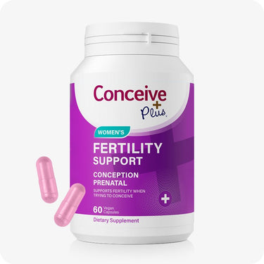Conceive Plus Women's Fertility Support bottle featuring a white and purple label with turquoise accents, displaying “Conception Prenatal” and “60 Vegan Capsules,” with two pink capsules placed in front to show supplement form.