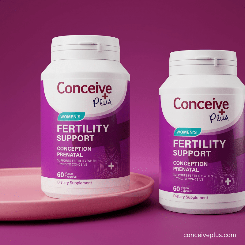 Two bottles of Conceive Plus women's fertility support supplements on a pink tray with a purple background.